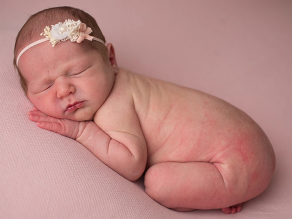 Soft pink background newborn photo editing.