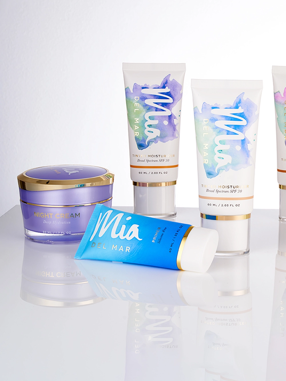 Collection of cosmetic tubes and jar with reflection and shadow making